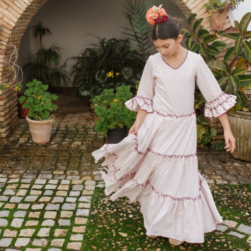 Bata rociera para niña de lunares coral y blanco con volantes canasteros - Carmen Garrido Flamenco
