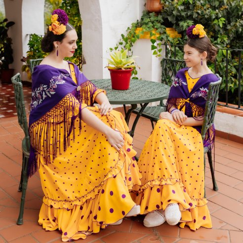 Vestido de flamenca para niña con falda de dos volantes y mantoncillo  flamenco bordado a juego con el vestido.
